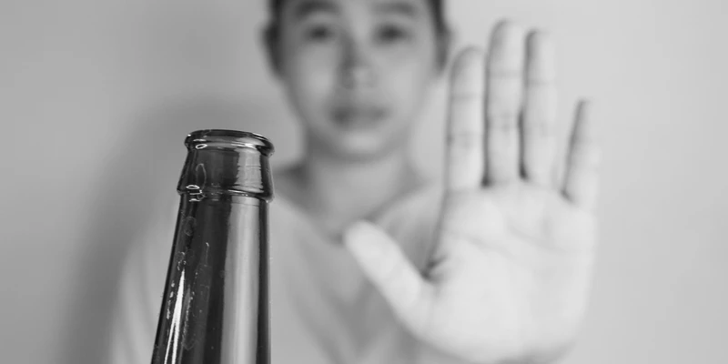 twilight alcohol detox man holding beer bottle hand