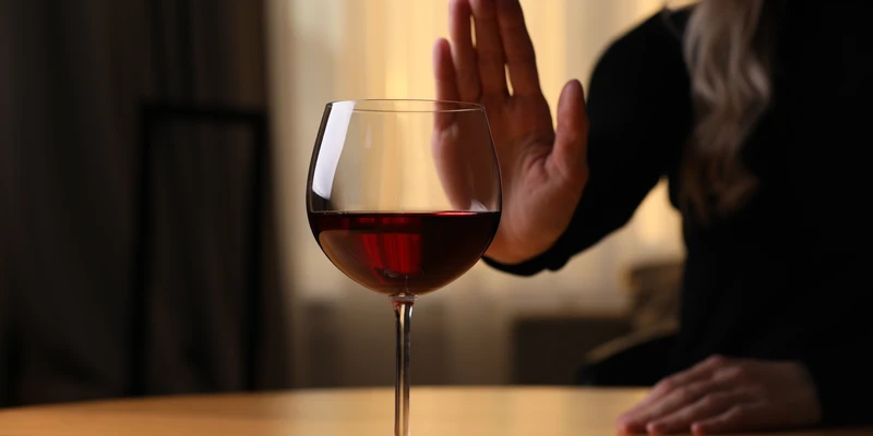 twilight alcohol detox woman sitting table glass wine