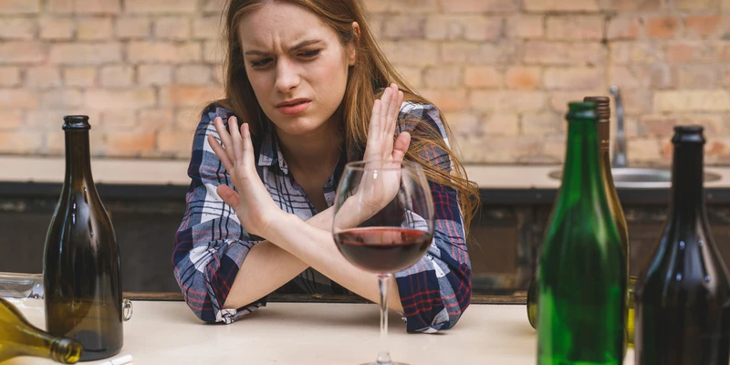 twilight alcohol detox woman sitting table glass wine