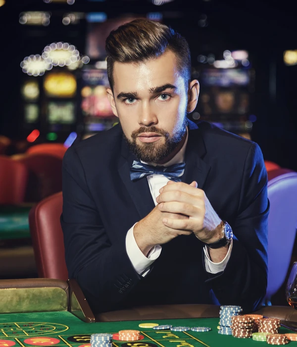 twilight gambling addiction man suit bow tie playing poker
