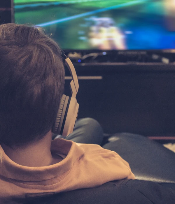twilight gaming addiction boy wearing headphones watching video game