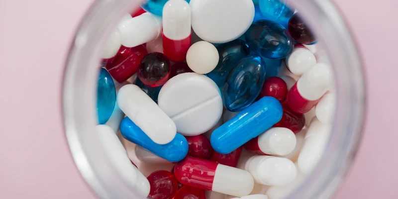 twilight opioid jar filled pills pink background