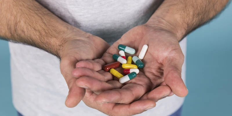 twilight opioid man holding pills hands