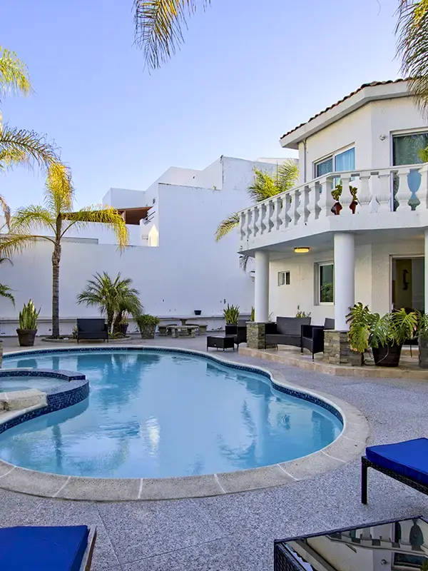 twilight pool lounge chairs palm trees