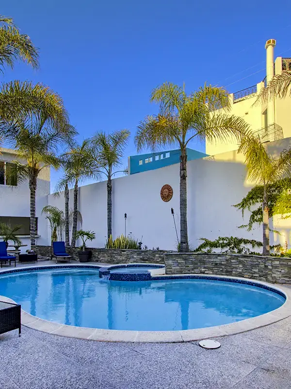 twilight pool palm trees white house background
