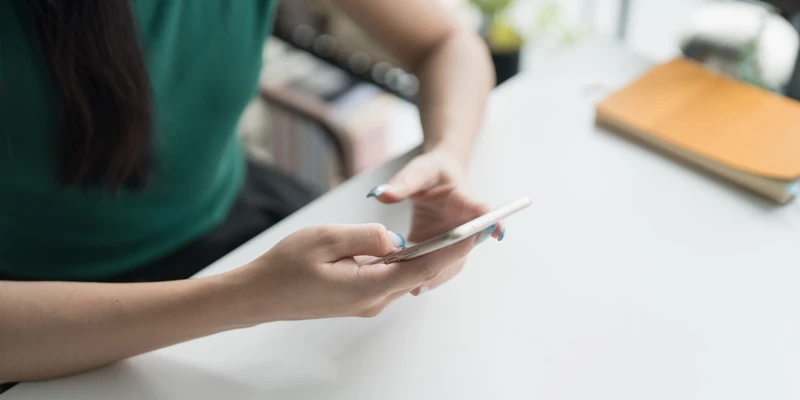 twilight shopping addiction woman sitting table using cell phone