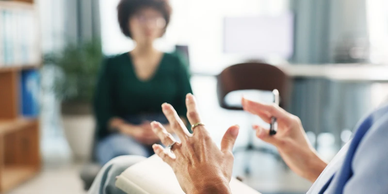 twilight therapy woman blue shirt sitting couch gesturing