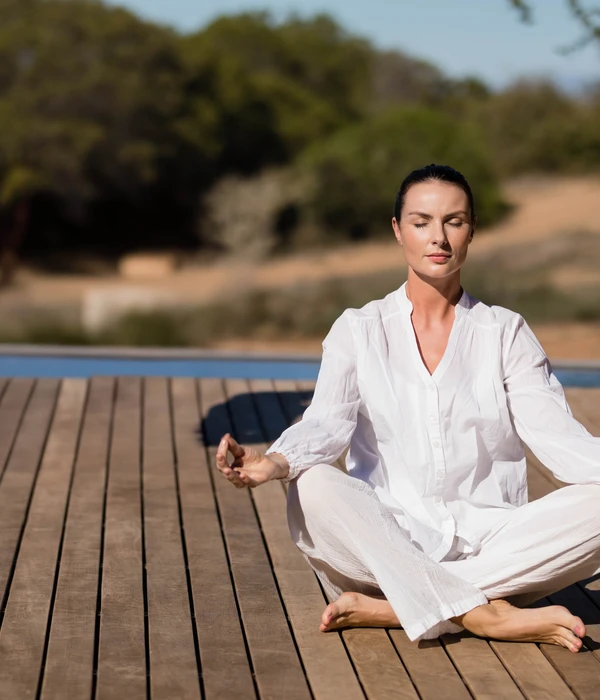 twilight yoga woman sitting wooden deck white shirt black